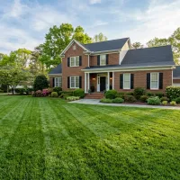 Healthy green lawn showing results of professional lawn care Graham NC services on a Piedmont home